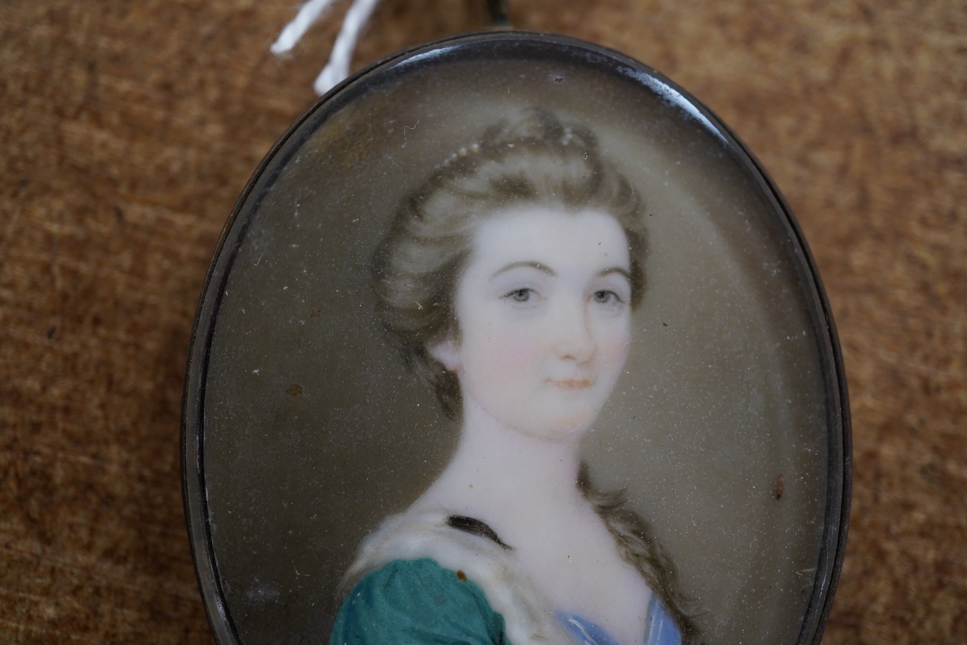 18th century School, Portrait miniature of a lady, indistinctly monogrammed and dated 1760? at 8 o'clock, 4 x 3cm. Condition - fair